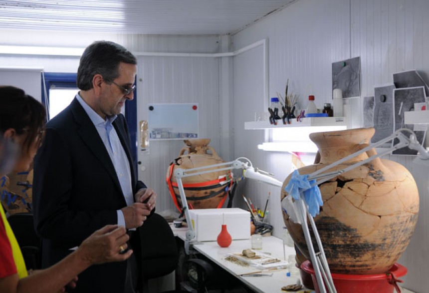 Antonis Samaras, the Prime Minister of the Hellenic Republic, looks at the ancient Greek vases which are being repaired by experts