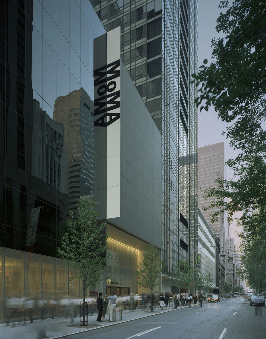 Photo showing a street on which there is a large and modern building with MoMA written on the side