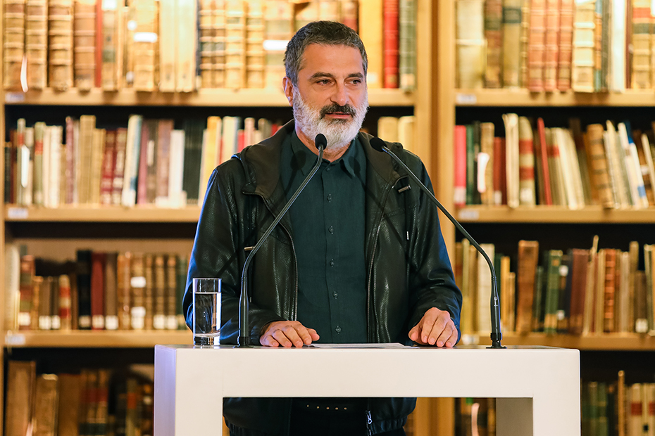 A man speaks at the podium