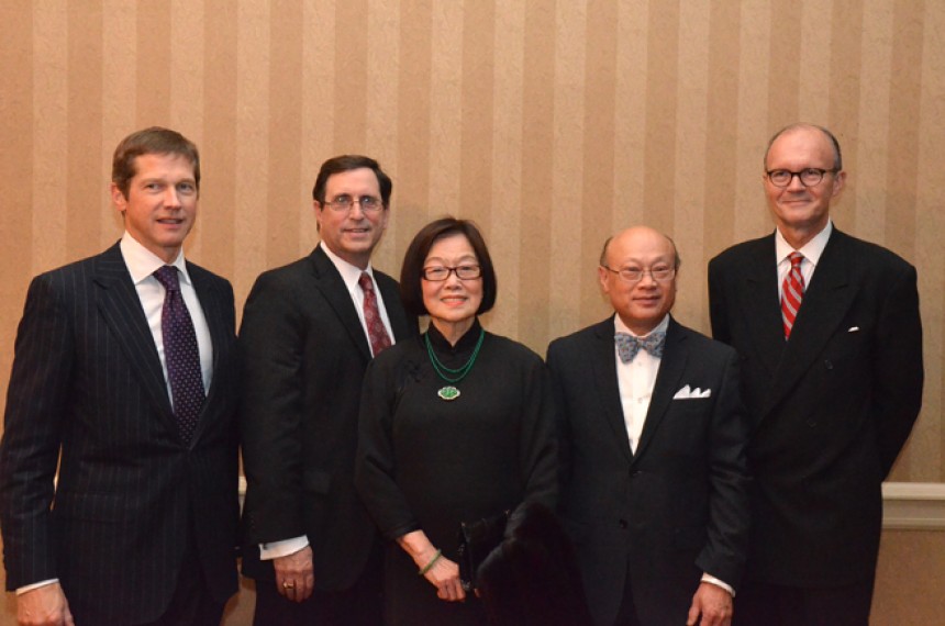 Four men and a woman standing for a commemorative photo