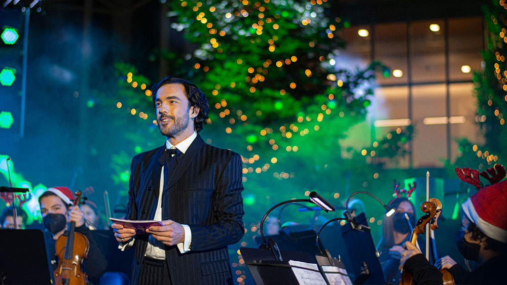 A man stands in front of an orchestra at the Stavros Niarchos Foundation Cultural Center