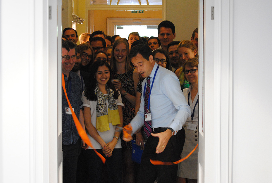 A member of staff at Chatham House cuts the ribbon opening the Stavros Niarchos Foundation Floor
