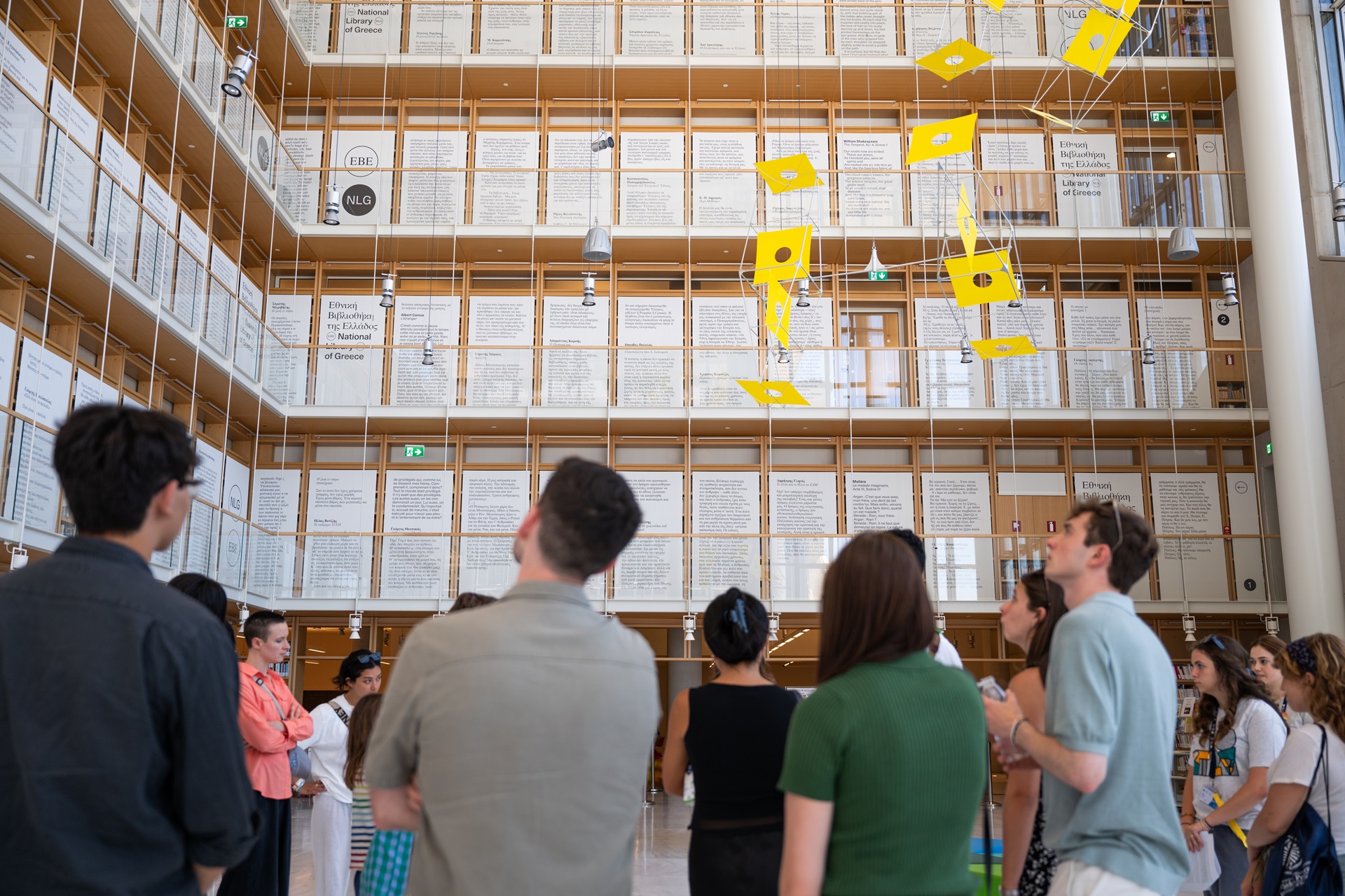 People looking at the books of the National Library of Greece.