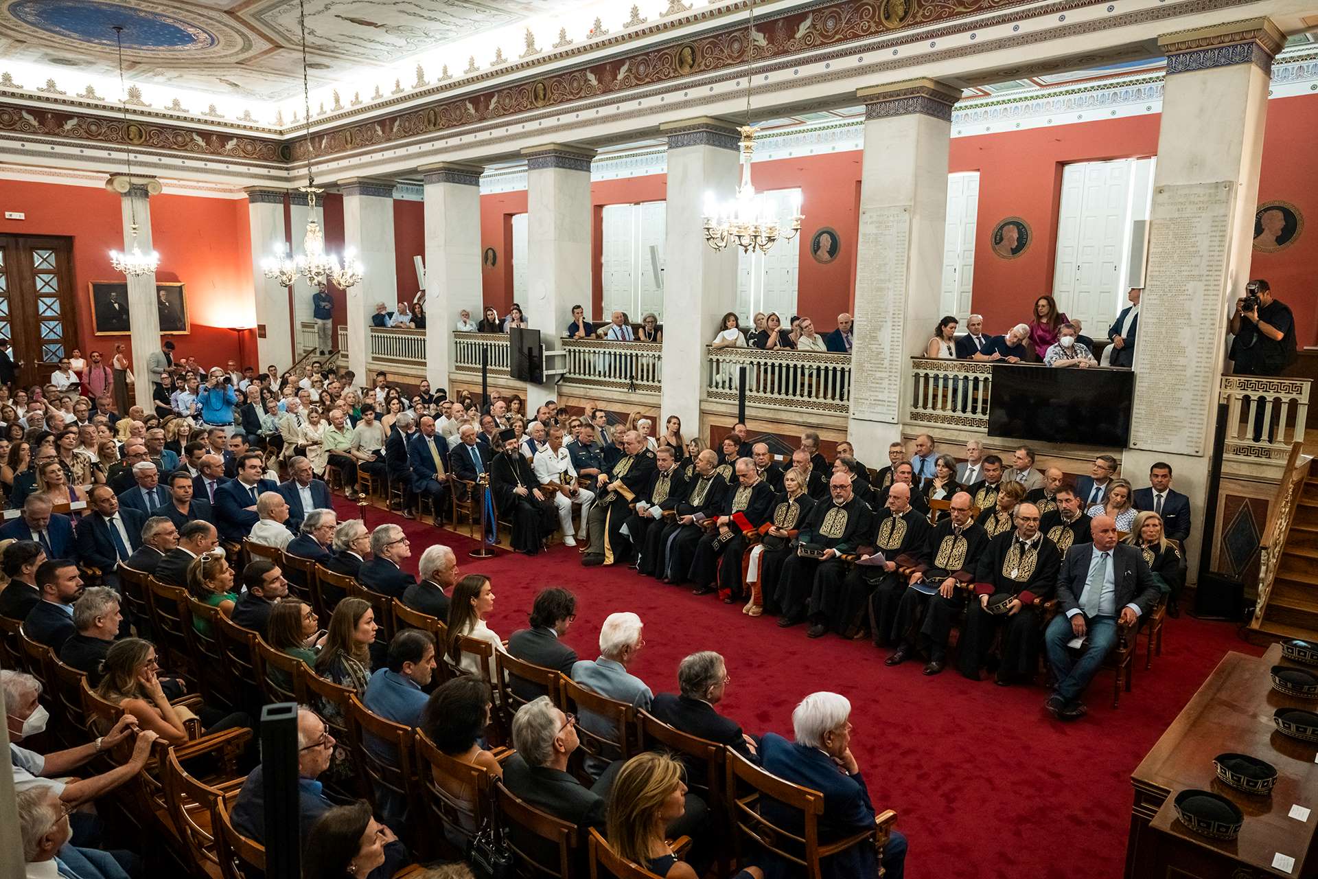 Photo of the audience, seated in their seats in the grand Grand Hall of the NKUA, during the ceremony.