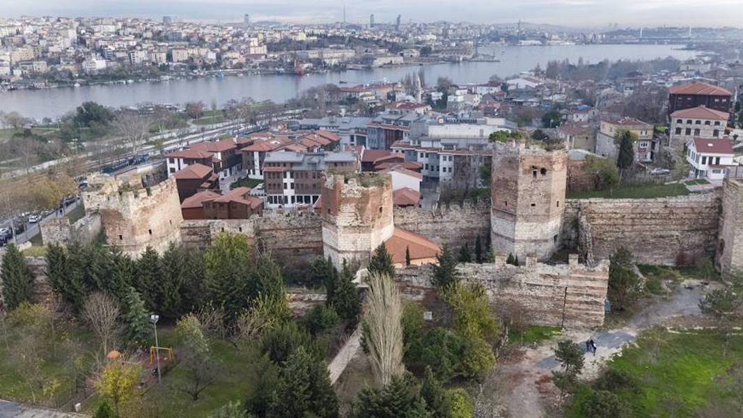 Aerial shot of Byzantine walls and towers in Istanbul with the modern city in the background.