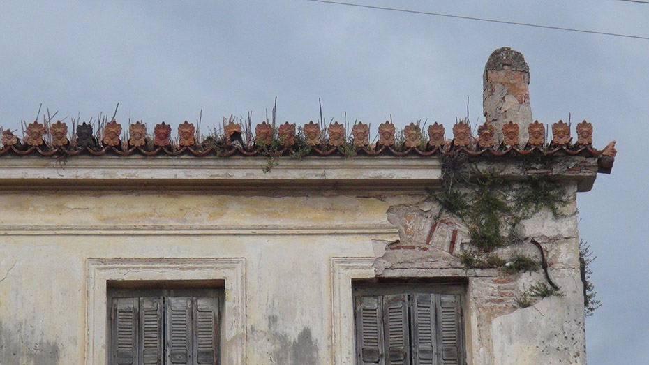 A close up view of a disintegrating corner of a building's roof