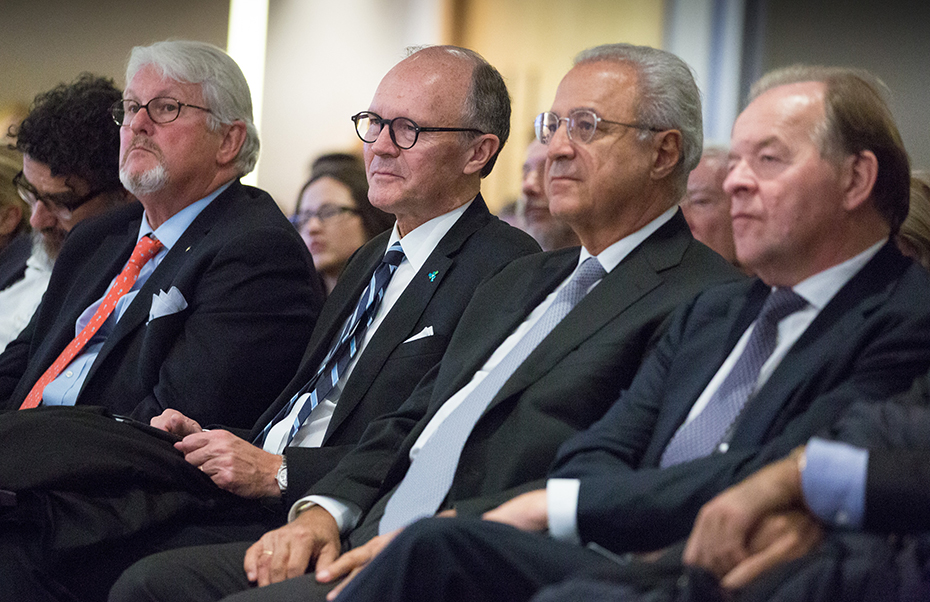Members of the audience sit and listen attentively