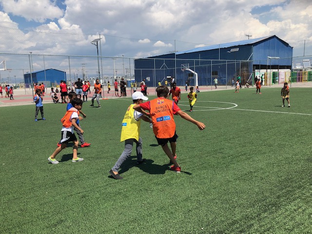 A group of children play a football match