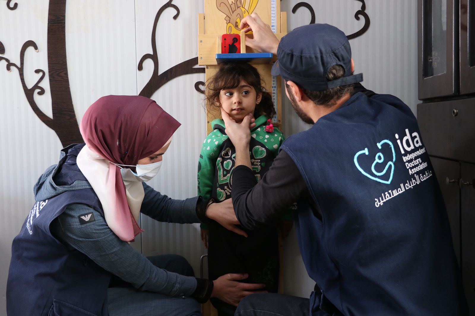 Staff from Independent Doctors Association provide care to a child.