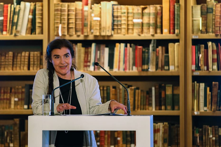 A woman speaks at the podium