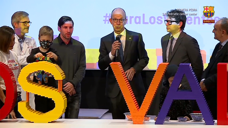 Members of the Stavros Niarchos Foundation stand next to Messi and a child from the Pediatric Cancer Center