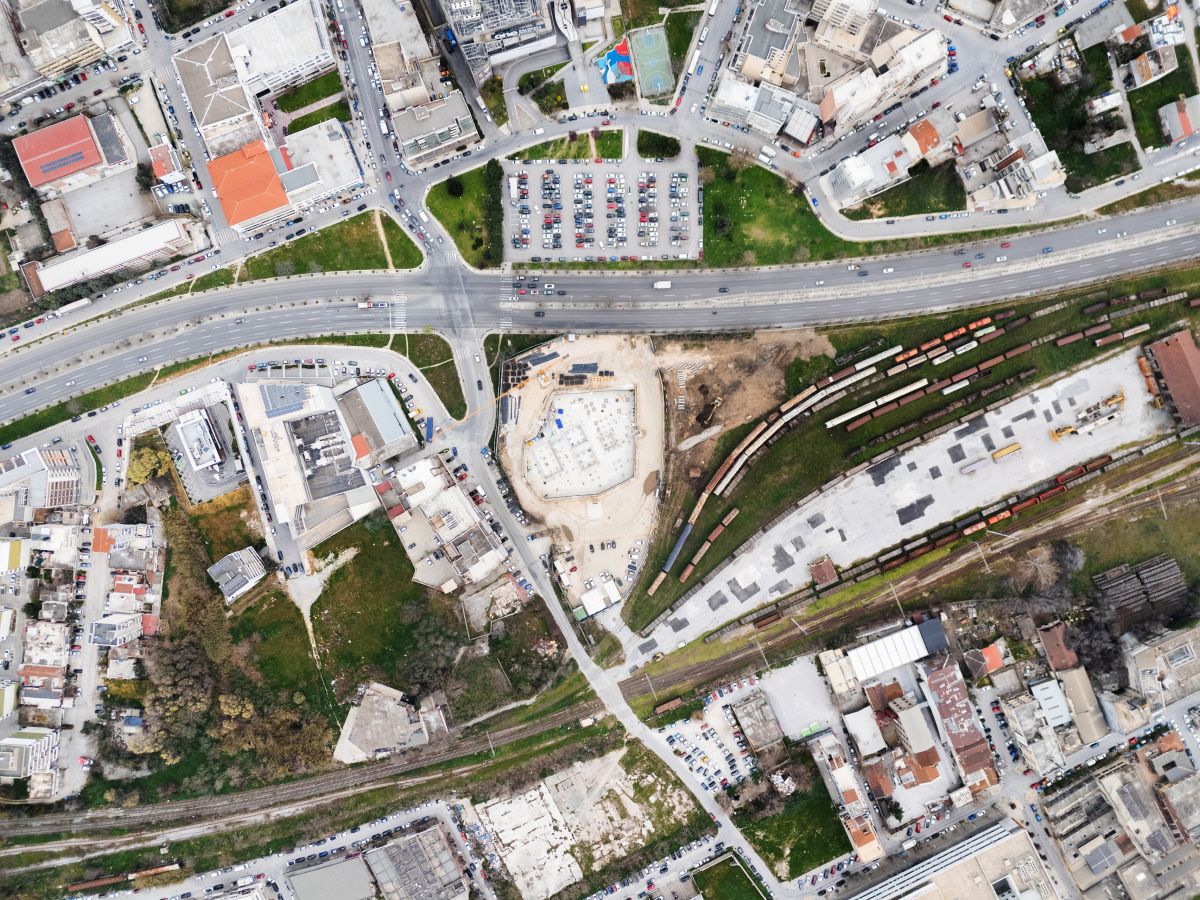 Aerial view of Holocaust Museum construction site in an urban neighborhood with roads in Thessalonki