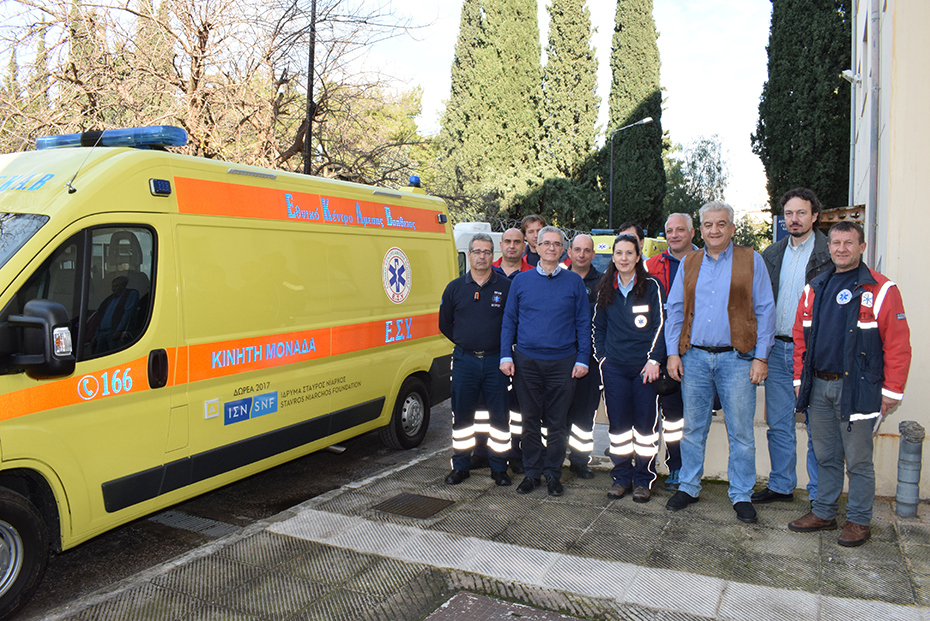 Crew members of EKAV stand for a picture in front of an ambulance