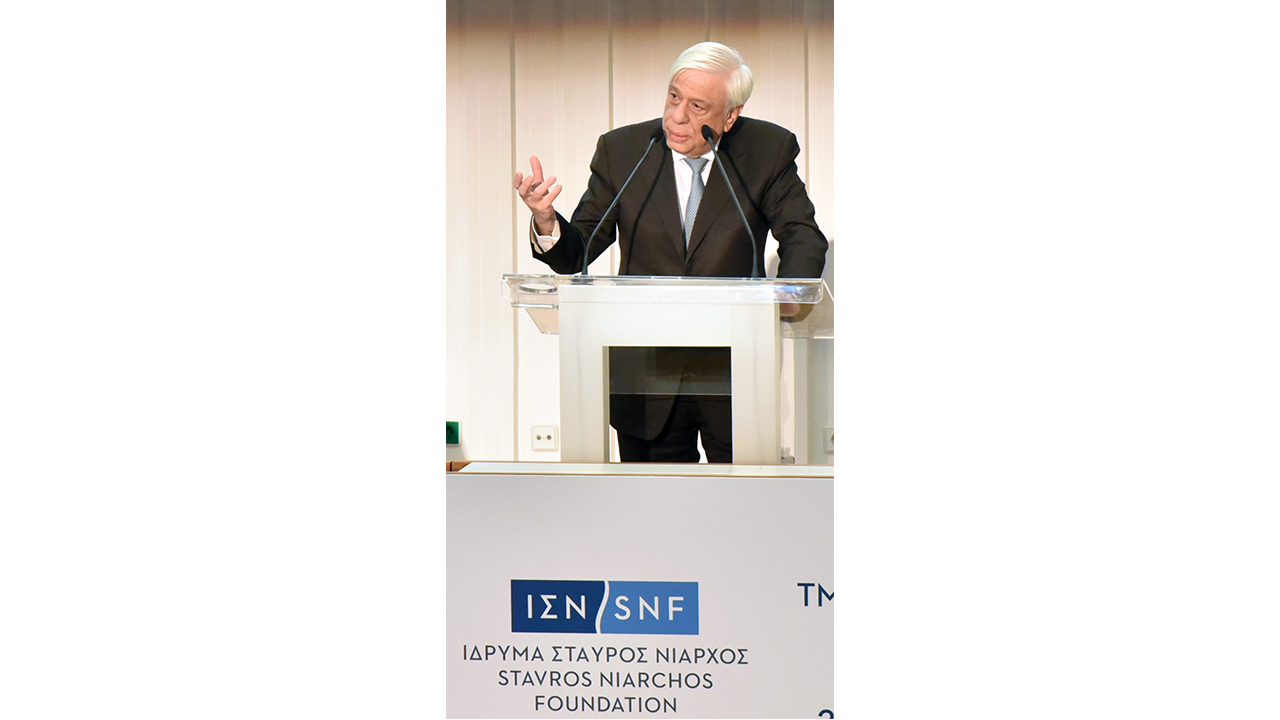 Mr. Prokopis Pavlopoulos stands on the podium of the Stavros Niarchos Foundation and makes a speech