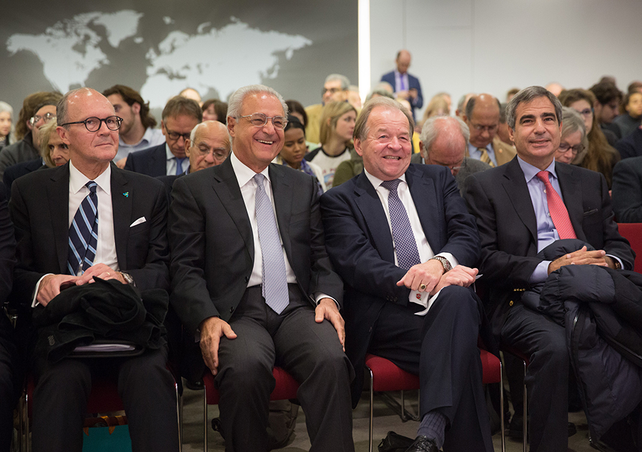 Members of the audience sit and laugh