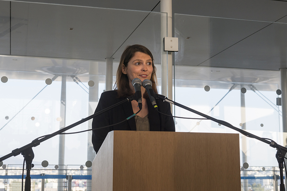 A woman speaks at the podium