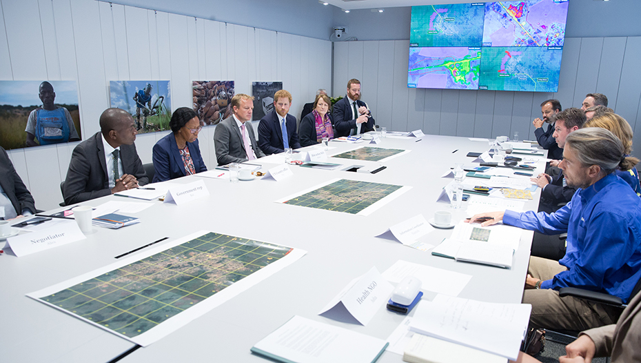Prince Harry sits in a conference room participating in a mine clearance scenario exercise