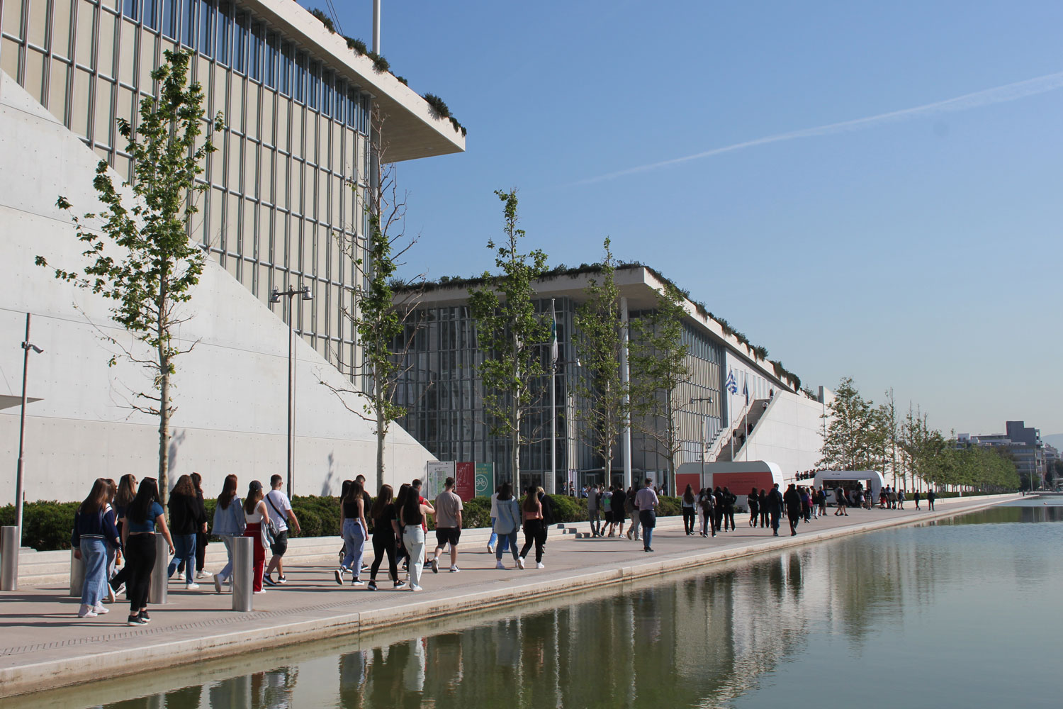 Students walk outside of the Stavros Niarchos Foundation Cultural Center