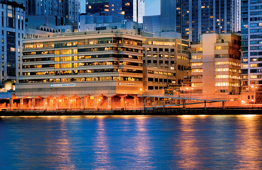The outside of the Hospital for Special Surgery building, which is in front of a river