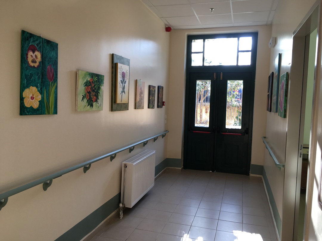 A hallway filled with paintings in the new facilities of the Elderly Care Unit of Lixouri in Kefalonia