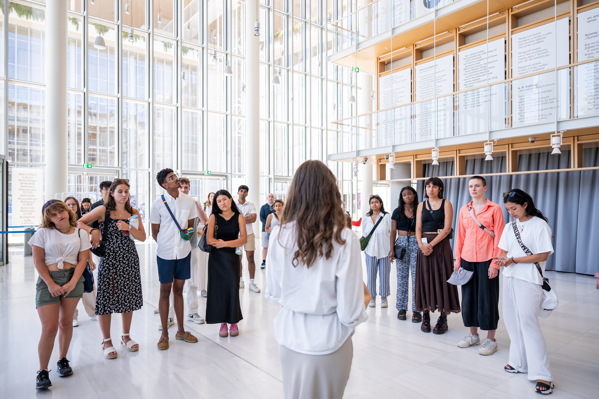 Visitors gathered in a circle around the guide at the National Library of Greece.