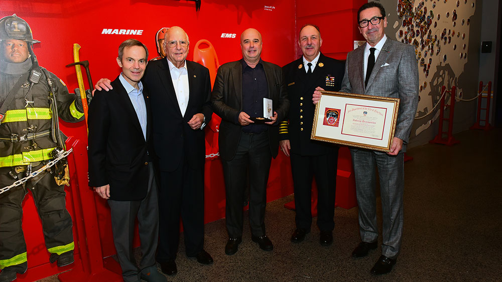 Andreas Dracopoulos, President of the Stavros Niarchos Foundation, together with members of the New York Fire Department stand for a commemorative photo