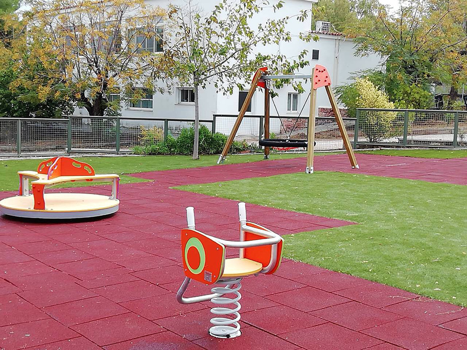 A playground with swings and other playing constructions