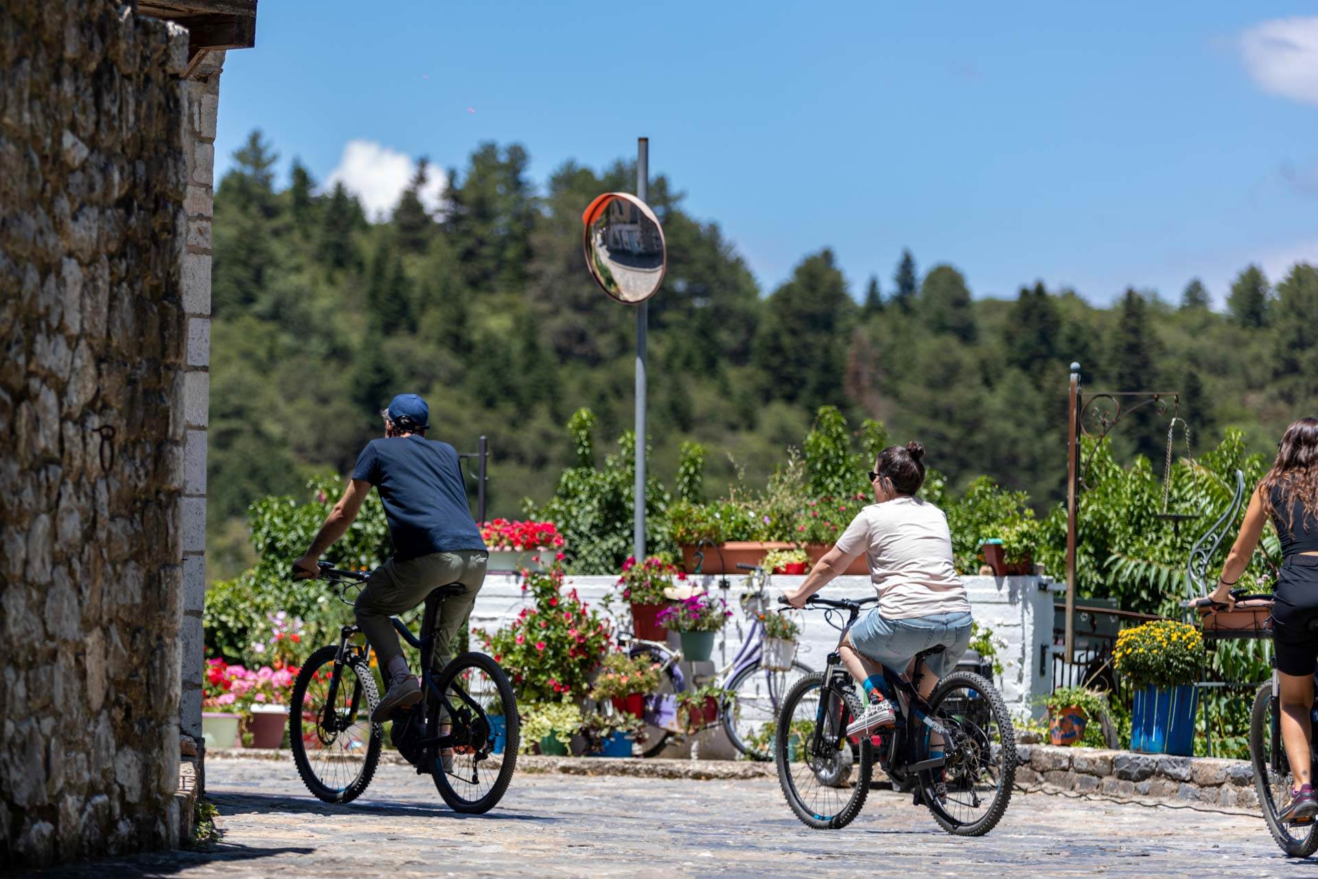 Two people cycling in the village.