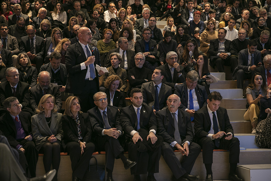 Photo showing the audience sitting and a man is standing and expressing his concerns into the microphone