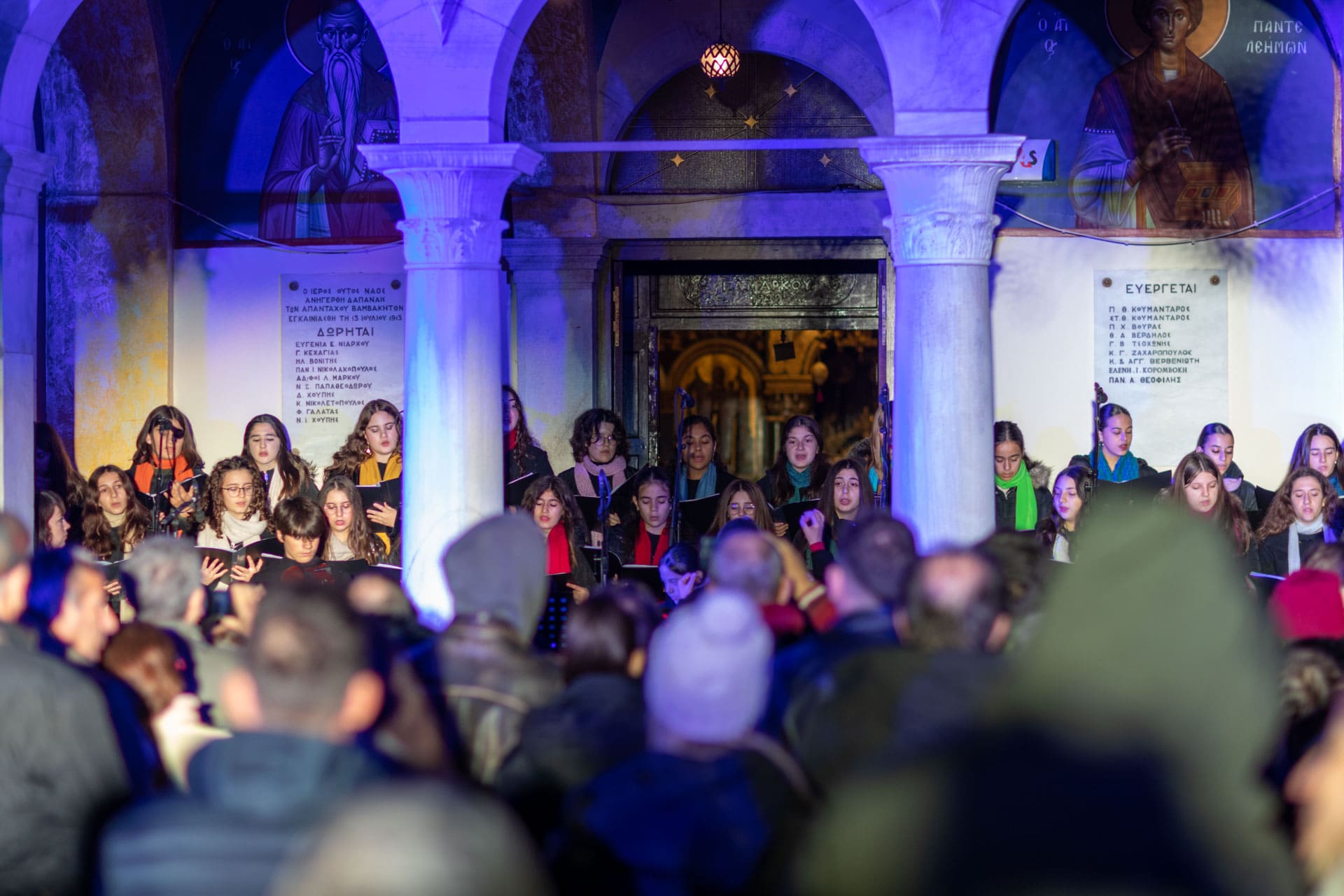 A choir sings in front of a church.