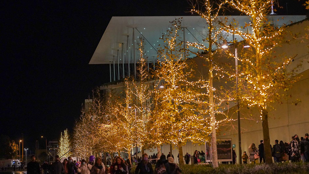 Many people gathered at the Stavros Niarchos Foundation Cultural Center, where the trees are decorated with lights