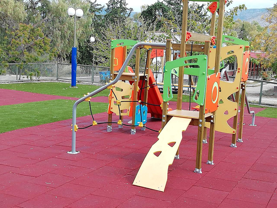 A playground set on top of soft, protective material and grass
