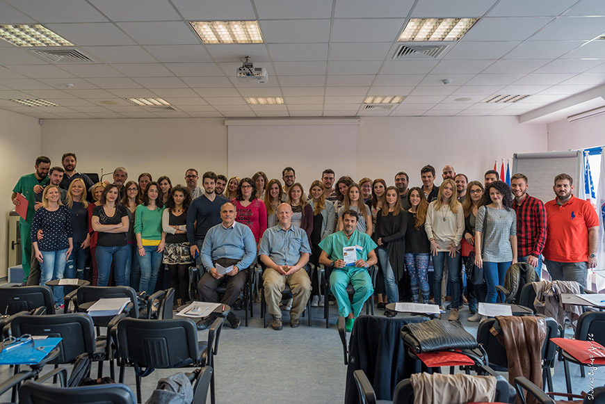 A group of medical students gather for a picture in the front of a classroom