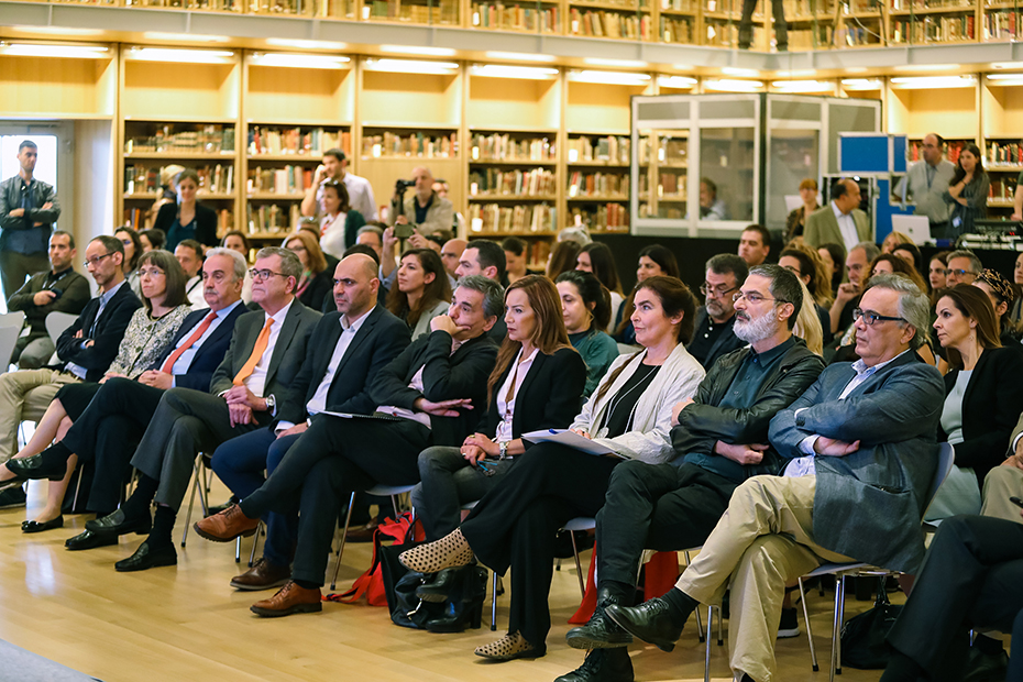 Photo of the audience sitting and watching a speech