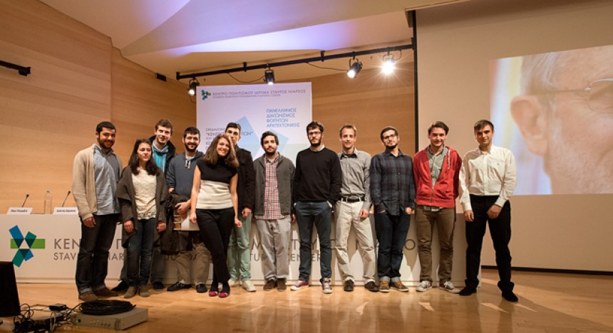 Twelve young adults stand on stage at the Stavros Niarchos Foundation Cultural Center