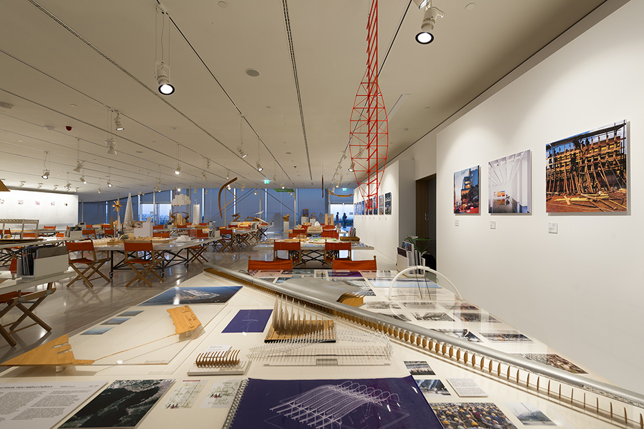 Photo showing the model, drawings and memos on a table