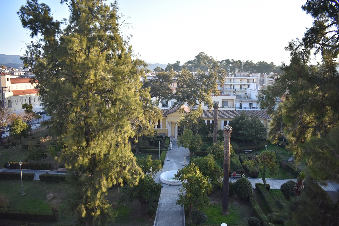 Photo taken from a drone showing a fountain and the four paths that start from it and pass through gardens and trees