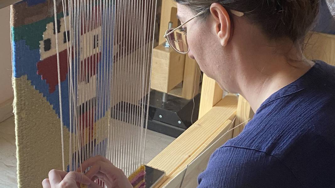 A woman working at a loom