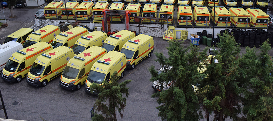Many ambulances parked in a parking lot