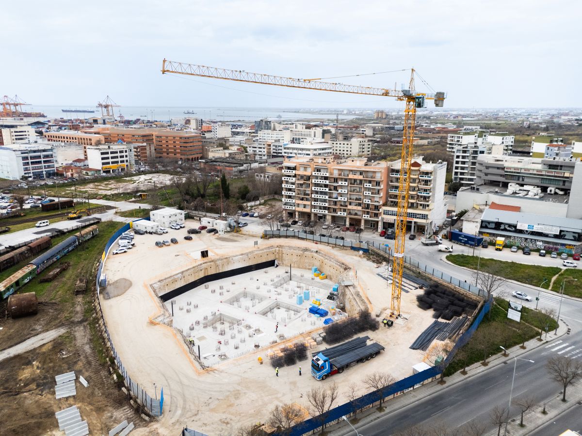 Aerial view of Holocaust Museum construction site in an urban neighborhood with roads in Thessaloniki.
